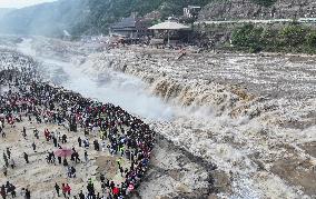 Tourists Visit The Hukou Waterfall - China