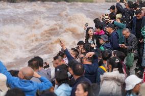 Tourists Visit The Hukou Waterfall - China