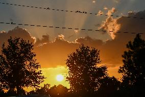 Sunset Between Clouds And Trees, In Florida