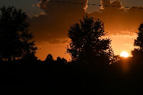 Sunset Between Clouds And Trees, In Florida