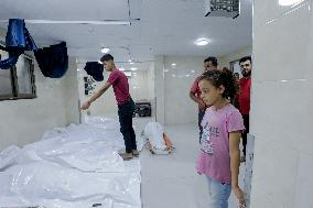 Relatives of the victims killed in the airstrike on Al-Mufti school in Nuseirat Camp