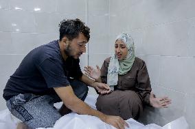 Relatives of the victims killed in the airstrike on Al-Mufti school in Nuseirat Camp