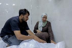 Relatives of the victims killed in the airstrike on Al-Mufti school in Nuseirat Camp