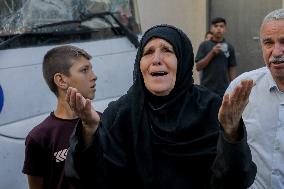 Relatives of the victims killed in the airstrike on Al-Mufti school in Nuseirat Camp