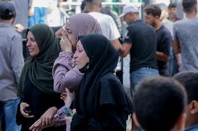 Relatives of the victims killed in the airstrike on Al-Mufti school in Nuseirat Camp