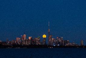 Full Moon Rises Over The Skyline In Toronto