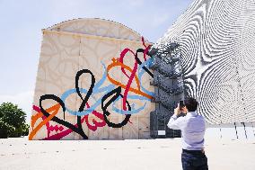 The Press Presentation Of The Mural Waves Only Exist Because The Wind Blows By EL Seed On The Exterior Walls Of Pirelli HangarBi