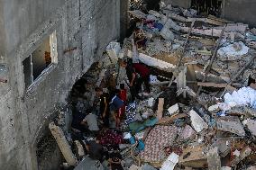 Palestinians Inspect Buildings Bombed