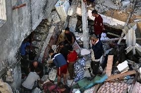 Palestinians Inspect Buildings Bombed