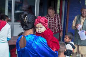 Health Worker Administers Vitamin A Capsule To Child In Nepal.