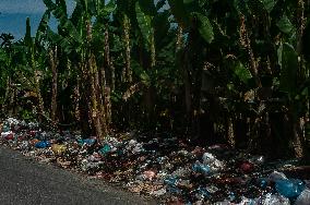 Plastic Waste Is Scattered On The Side Of A Road - Indonesia