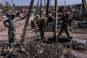 Non-Local Labourers Work At A Construction Site In Kashmir