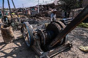 Non-Local Labourers Work At A Construction Site In Kashmir