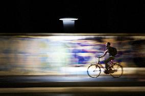 Urban Cyclist On A Foggia Bike Lane At Night