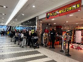 Huge Line-up To Enter A Shop Selling Halloween Costumes And Decorations In Toronto