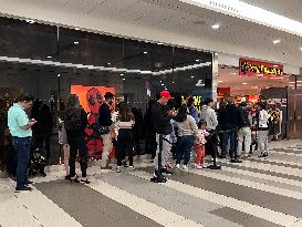 Huge Line-up To Enter A Shop Selling Halloween Costumes And Decorations In Toronto