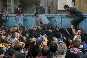 Displaced Palestinians Queue To Buy Bread - Gaza