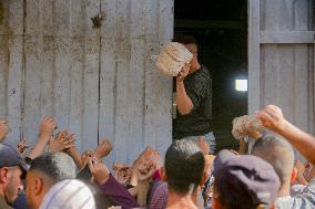 Displaced Palestinians Queue To Buy Bread - Gaza