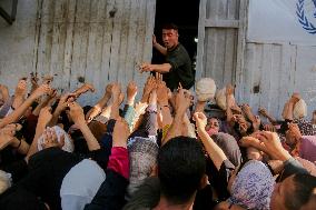 Displaced Palestinians Queue To Buy Bread - Gaza