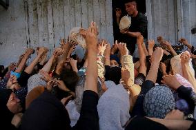 Displaced Palestinians Queue To Buy Bread - Gaza