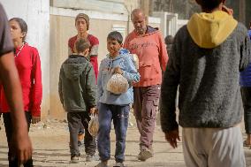 Displaced Palestinians Queue To Buy Bread - Gaza