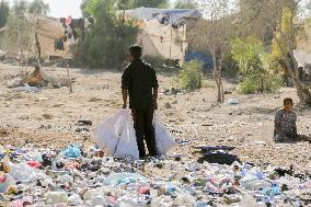 Workers Labor In A Coal-Making Pit - Gaza