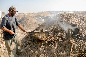 Workers Labor In A Coal-Making Pit - Gaza