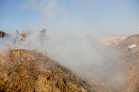 Workers Labor In A Coal-Making Pit - Gaza