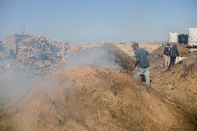 Workers Labor In A Coal-Making Pit - Gaza