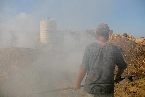 Workers Labor In A Coal-Making Pit - Gaza