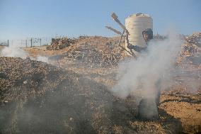 Workers Labor In A Coal-Making Pit - Gaza