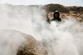 Workers Labor In A Coal-Making Pit - Gaza