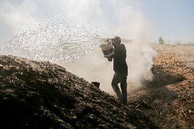 Workers Labor In A Coal-Making Pit - Gaza