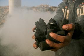 Workers Labor In A Coal-Making Pit - Gaza