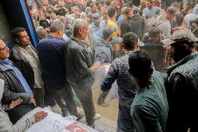 Palestinians Collect Flour - Gaza