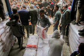 Palestinians Collect Flour - Gaza