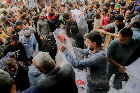 Palestinians Collect Flour - Gaza