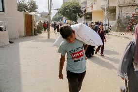 Palestinians Collect Flour - Gaza