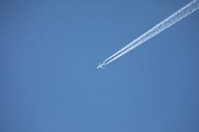 Commercial Airplane In Flight: Intercontinental Journey With Contrail