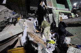 Rescuers Work At The Site Of A Glide Bomb Attack On A Residential Building In Kharkiv