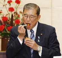 Japan PM Ishiba eats persimmon