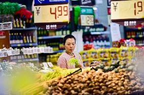 Consumers shop at a supermarket in Qingzhou