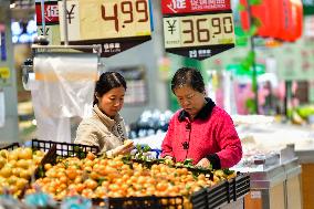 Consumers shop at a supermarket in Qingzhou