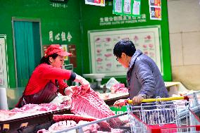 Consumers shop at a supermarket in Qingzhou