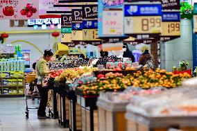 Consumers shop at a supermarket in Qingzhou