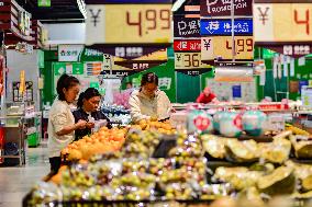 Consumers shop at a supermarket in Qingzhou