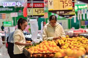 Consumers shop at a supermarket in Qingzhou