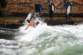 Surfers Brave The Icy Waters Of The Eisbach Stream In Munich In Autumn