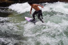 Surfers Brave The Icy Waters Of The Eisbach Stream In Munich In Autumn