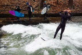 Surfers Brave The Icy Waters Of The Eisbach Stream In Munich In Autumn